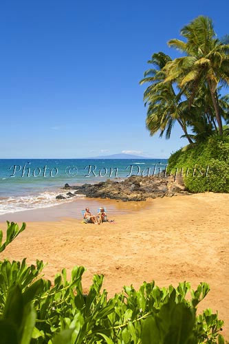 Couple relaxing at Changs Beach, Maui, Hawaii - Hawaiipictures.com