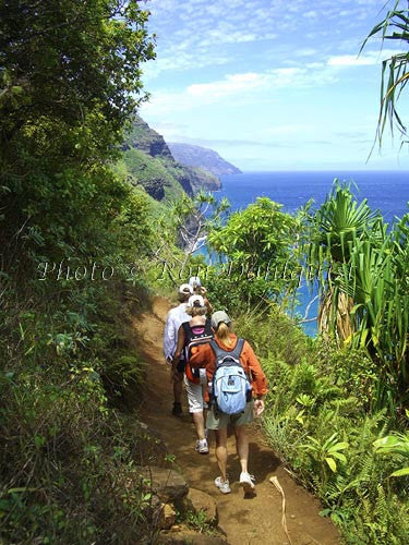 Hikers on the Kalalau Trail which runs along the Na Pali coast. Kauai, Hawaii Picture Photo - Hawaiipictures.com
