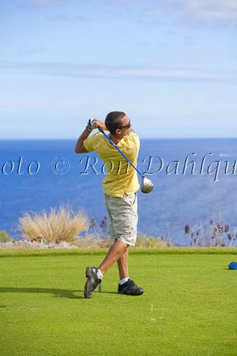 Young man hitting a tee shot at The Challenge at Manele golf course, Lanai, Hawaii - Hawaiipictures.com