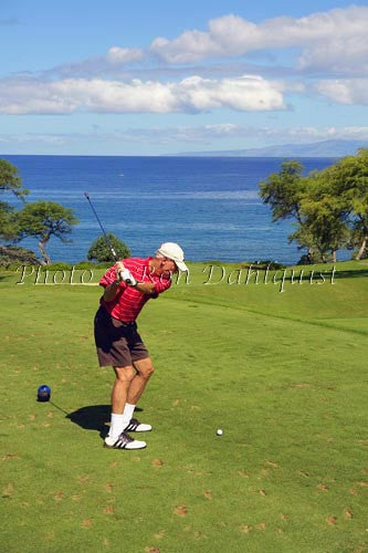 Man swinging golf club at Makena Golf Course, Maui, Hawaii - Hawaiipictures.com