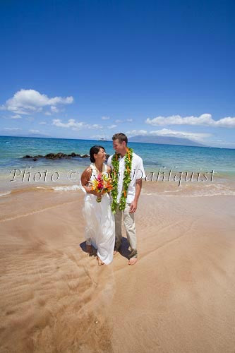 Hawaiian wedding. Newly married couple walking on the beach, Makena, Maui, Hawaii - Hawaiipictures.com