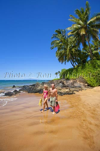 Couple about to go snorkeling at Changs Beach, Makena, Maui, Hawaii - Hawaiipictures.com