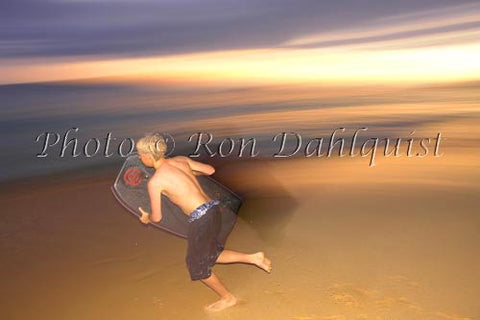 Teenager running to catch a wave as the sun goes down. Big Beach, Makena, Maui, Hawaii - Hawaiipictures.com