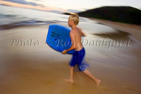Teenager running to catch a wave as the sun goes down. Big Beach, Makena, Maui, Hawaii Picture - Hawaiipictures.com