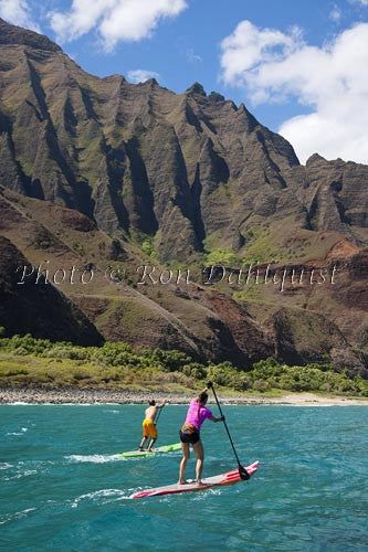 Stand-up paddling along the NaPali coastline of Kauai, Hawaii - Hawaiipictures.com