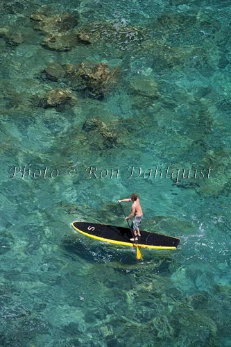 Man stand-up paddle boarding over shallow reef on Lanai, Hawaii Photo - Hawaiipictures.com