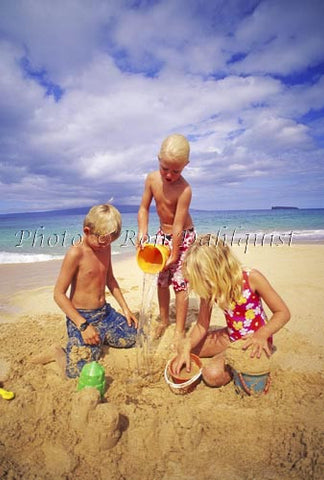 Three young children, playing in the sand at Big Beach, Maui, Hawaii - Hawaiipictures.com